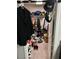 A walk-in closet filled with clothes, shoes, hats, and bags on the floor and shelves at 8113 Mineola Palms St, Las Vegas, NV 89139