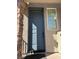 Stylish front door framed by brick accents, offering a warm and inviting entrance at 8113 Mineola Palms St, Las Vegas, NV 89139