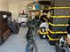 Spacious garage featuring epoxy floors, storage shelves, a full sized sofa, a bicycle, and containers at 8113 Mineola Palms St, Las Vegas, NV 89139