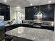 Gorgeous kitchen with a large island, stainless steel appliances, and stylish lighting at 8113 Mineola Palms St, Las Vegas, NV 89139