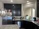 Beautiful kitchen with stainless steel appliances, granite counters, and dark cabinets at 8113 Mineola Palms St, Las Vegas, NV 89139