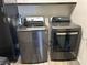 Modern laundry machines in stainless steel, with gray wood-look floors at 8113 Mineola Palms St, Las Vegas, NV 89139