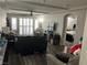 Spacious living room with ample seating, plantation shutters, and views to the bedroom at 8113 Mineola Palms St, Las Vegas, NV 89139