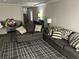 Comfortable living room with sofas, a patterned rug, and neutral decor at 8113 Mineola Palms St, Las Vegas, NV 89139