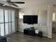 Bright living room with a large TV and plantation shutters on the sliding glass door at 8113 Mineola Palms St, Las Vegas, NV 89139