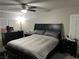 Bedroom with a dark wood furniture set, ceiling fan, and a window with plantation shutters at 8113 Mineola Palms St, Las Vegas, NV 89139