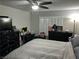 Main bedroom with a king bed, dark wood furniture, and plantation shutters at 8113 Mineola Palms St, Las Vegas, NV 89139