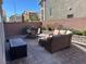 A spacious backyard patio featuring outdoor seating, dining area, storage, and a brick perimeter wall at 8113 Mineola Palms St, Las Vegas, NV 89139
