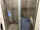 Modern shower featuring stylish stone tile, glass door, and chrome shower head at 8113 Mineola Palms St, Las Vegas, NV 89139