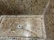 Close up on walk in shower with floor to ceiling stone look shower surround at 8113 Mineola Palms St, Las Vegas, NV 89139