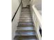 View of hardwood staircase with black handrail and white trim at 8113 Mineola Palms St, Las Vegas, NV 89139