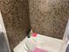Close up on tub with brown textured walls and shampoo bottles at 8113 Mineola Palms St, Las Vegas, NV 89139