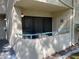 View of the balcony in the stucco condominium with a view of the greenery and an entrance to an outside side door at 840 N Sloan Ln # 102, Las Vegas, NV 89110