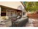 Cozy outdoor back patio seating area with a mature shade tree at 85 Alerion St, Las Vegas, NV 89138