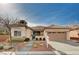 Charming single-story home with desert landscaping, a two-car garage, and a tiled roof at 85 Alerion St, Las Vegas, NV 89138