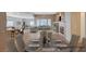 Spacious open-plan living room and kitchen with a fireplace, and dining area at 85 Alerion St, Las Vegas, NV 89138