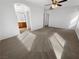 Bright bedroom featuring neutral carpeting, ceiling fan, and ensuite bathroom access at 8962 Rufina St, Las Vegas, NV 89148