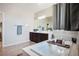 Bright bathroom featuring a soaking tub, dark wood cabinets, and a large mirror at 9643 Ponderosa Skye Ct, Las Vegas, NV 89166