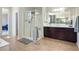 Bathroom featuring a glass enclosed shower, dark cabinets, and tile floors at 9643 Ponderosa Skye Ct, Las Vegas, NV 89166