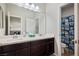 This bathroom features a dual sink vanity with dark cabinets and a shower with a Baby Yoda shower curtain at 9643 Ponderosa Skye Ct, Las Vegas, NV 89166