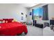 This bedroom has a full size bed with a red comforter, a small desk, and grey curtains at 9643 Ponderosa Skye Ct, Las Vegas, NV 89166