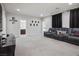 Bonus room area featuring an oversized gray sofa with a carpeted floor at 9643 Ponderosa Skye Ct, Las Vegas, NV 89166