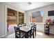 Dining room features a dark wood table set with grey cushioned chairs and sliding glass doors at 9643 Ponderosa Skye Ct, Las Vegas, NV 89166