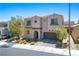 Two-story home featuring mature landscaping, a private entrance, and a convenient two-car garage at 9643 Ponderosa Skye Ct, Las Vegas, NV 89166