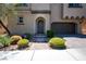 Close up of front exterior of stucco home featuring desert landscaping and a paver driveway at 9643 Ponderosa Skye Ct, Las Vegas, NV 89166
