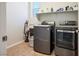 This laundry room features a front loading washer, a dryer, and shelving for storage at 9643 Ponderosa Skye Ct, Las Vegas, NV 89166
