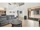 Bright living room with high ceilings, a gray sofa, and view to the outside patio at 9643 Ponderosa Skye Ct, Las Vegas, NV 89166