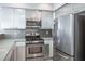 Modern kitchen boasts stainless steel appliances and ample cabinet space for organized storage at 9932 Twilight Walk Ave, Las Vegas, NV 89149