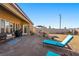 A brick patio, cozy seating, and a dining area create a perfect backyard for outdoor relaxation and entertainment at 1000 E Enchanted Mesa St, Pahrump, NV 89048