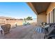 Covered patio extends to a spacious backyard with seating, grill, and open space for outdoor activities at 1000 E Enchanted Mesa St, Pahrump, NV 89048