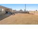 Expansive backyard featuring a brick patio and a large open area, perfect for outdoor living and recreation at 1000 E Enchanted Mesa St, Pahrump, NV 89048