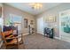 Carpeted bedroom with ceiling fan and view to next room at 1000 E Enchanted Mesa St, Pahrump, NV 89048