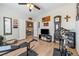 Large, light-filled exercise room with wood-look floors, a ceiling fan, and stylish decorative accents at 1000 E Enchanted Mesa St, Pahrump, NV 89048