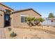 A closer look at the home's front entrance, showcasing the desert landscaping and a secure screen door at 1000 E Enchanted Mesa St, Pahrump, NV 89048