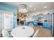 Bright kitchen featuring blue cabinets, stainless steel appliances, and a modern lighting fixture at 1000 E Enchanted Mesa St, Pahrump, NV 89048