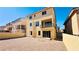 A yellow home featuring a balcony and low-maintenance dirt backyard at 10716 Shasta Glow Ct, Henderson, NV 89052