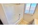 Bathroom with a white tub and shower combination and window at 10716 Shasta Glow Ct, Henderson, NV 89052