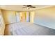 Neutral bedroom with a ceiling fan and a view to an open entryway at 10716 Shasta Glow Ct, Henderson, NV 89052