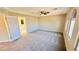 Spacious bedroom with neutral color palette and a ceiling fan with attached bathroom at 10716 Shasta Glow Ct, Henderson, NV 89052