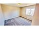 Empty bedroom with carpet, a window, and an overhead light at 10716 Shasta Glow Ct, Henderson, NV 89052