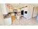 Well-lit kitchen with tile flooring, granite countertops, and stainless steel appliances, including a range at 10716 Shasta Glow Ct, Henderson, NV 89052