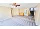 Living room featuring a wet bar, carpet, and access to the stairway at 10716 Shasta Glow Ct, Henderson, NV 89052