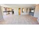 Open floor plan showcasing tiled floors connecting the living area to the kitchen with arched doorways at 10716 Shasta Glow Ct, Henderson, NV 89052