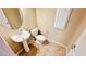 Powder room featuring pedestal sink, toilet, and tile flooring at 10716 Shasta Glow Ct, Henderson, NV 89052