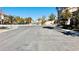 View of a quiet residential street with well-maintained landscaping and sidewalks on a sunny day at 10716 Shasta Glow Ct, Henderson, NV 89052