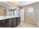 Bathroom featuring double sinks, a large mirror, and a glass-enclosed shower at 11094 Arcadia Sunrise Dr, Henderson, NV 89052